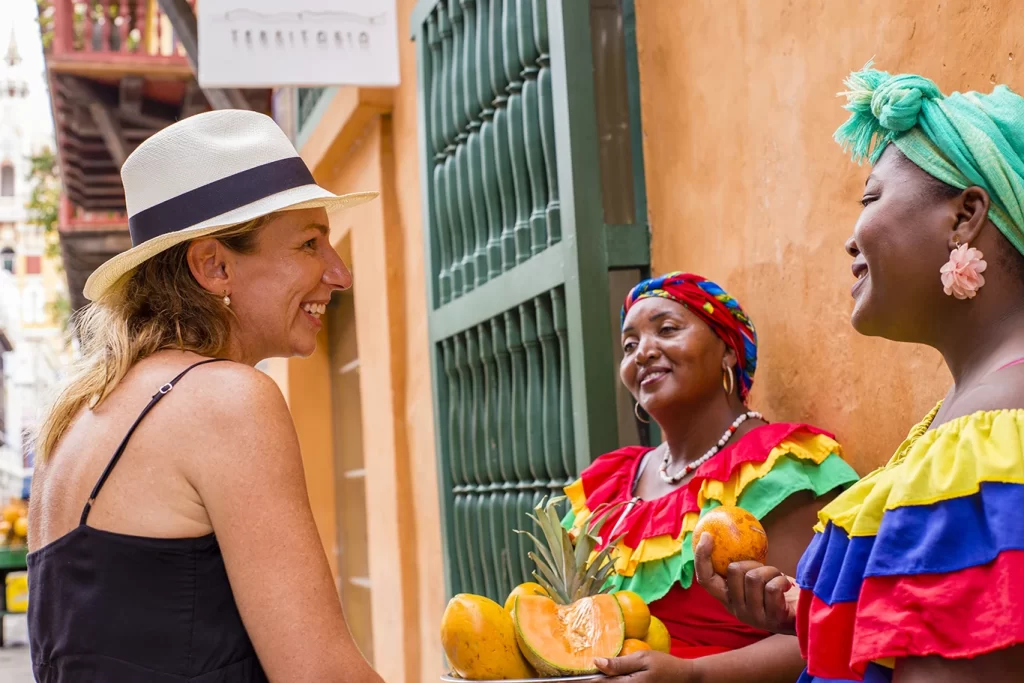 Traveler interacting with palenquera during One Day Photo Tour in Cartagena