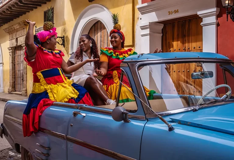 A black solo female traveler followed by a local photographer in a vintage car ride